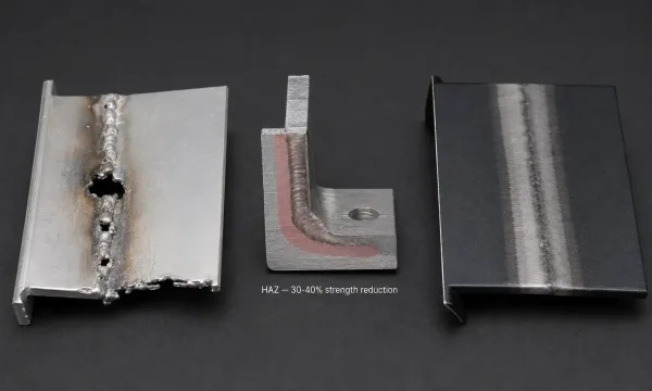 Examples of common welding defects on aluminum enclosures including burn-through, HAZ softening, and weld discoloration before anodizing