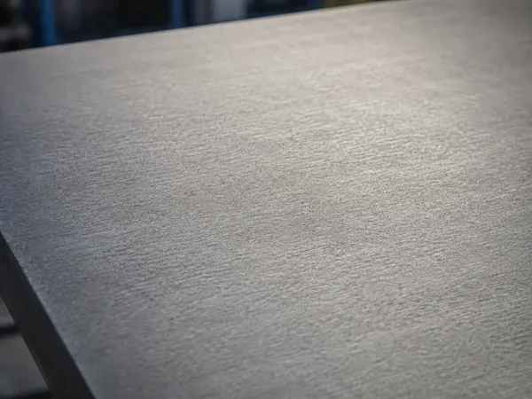 Close-up of ground metal surface with uniform matte texture
