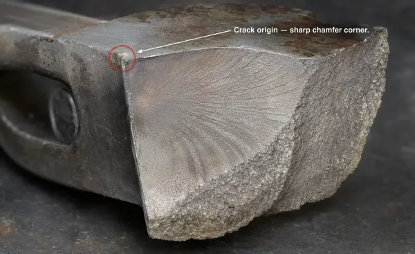 Macro photograph of a fatigue crack originating from a sharp chamfer corner on a fractured steel mechanical component