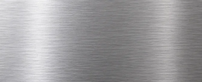 Brushed stainless steel sheet metal surface showing parallel grain texture lines